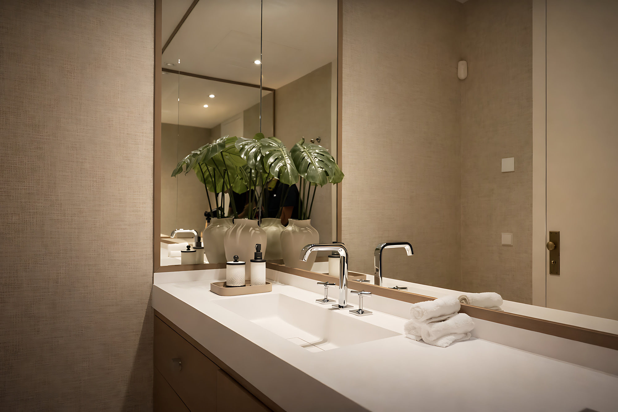 Minimal vanity and mirror composition with restrained luxury finishes in a bathroom at Villa Adriana