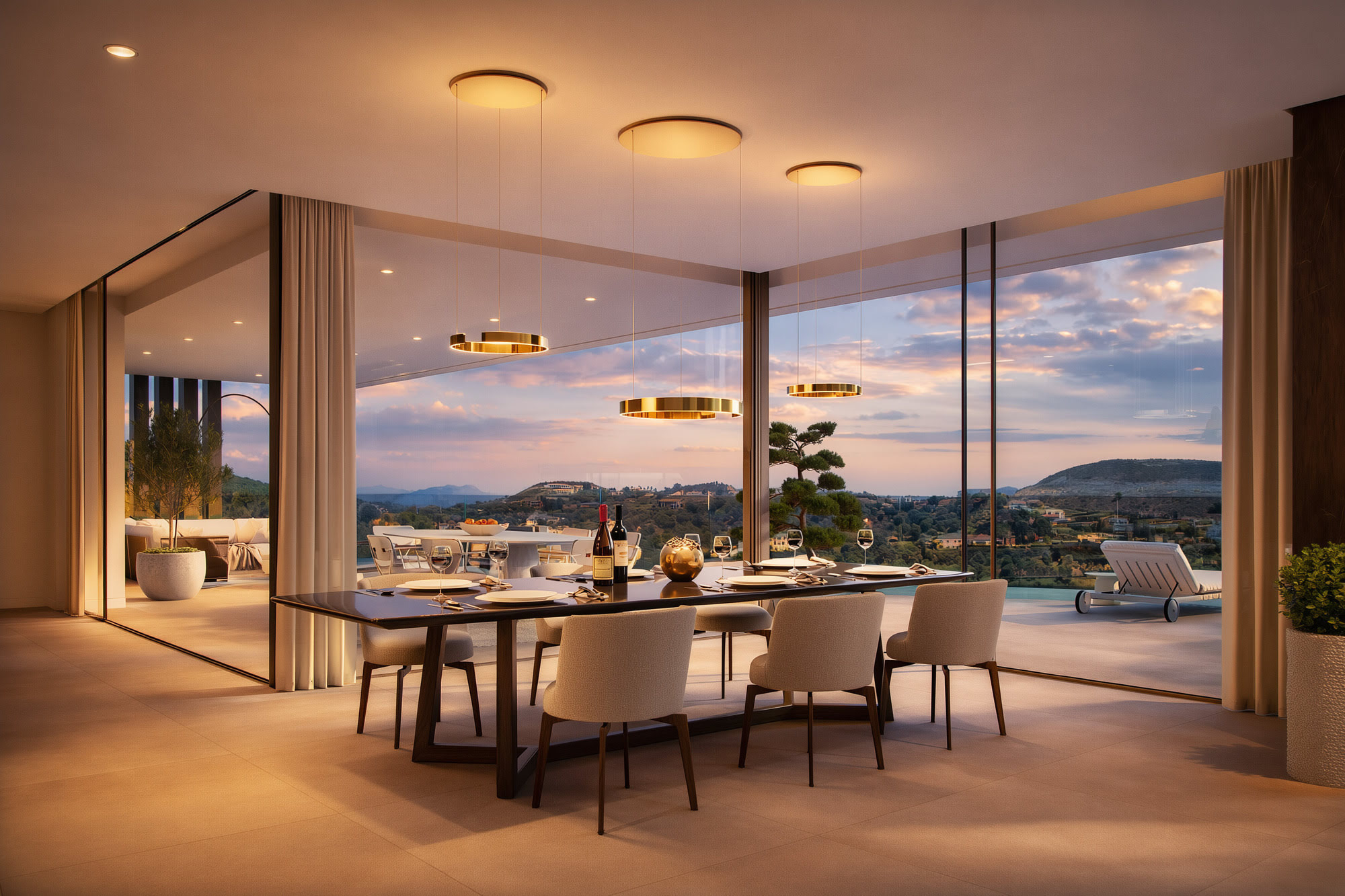 Dining area at Villa Alegría with full-height sliding glass doors and wide sunset views over La Zagaleta