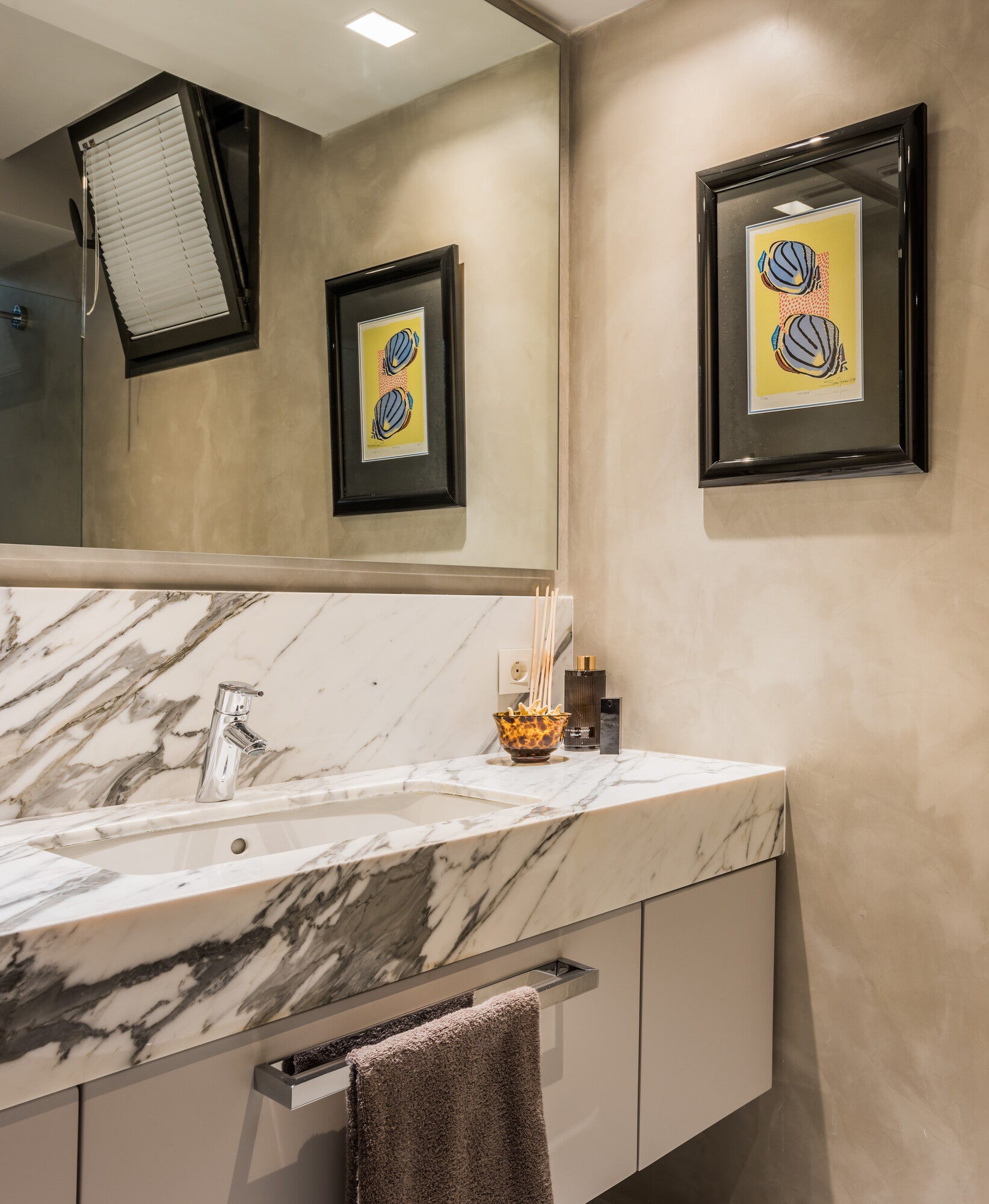 Guest powder room at Villa Australia with marble vanity, framed artwork and elegant hotel-style detailing