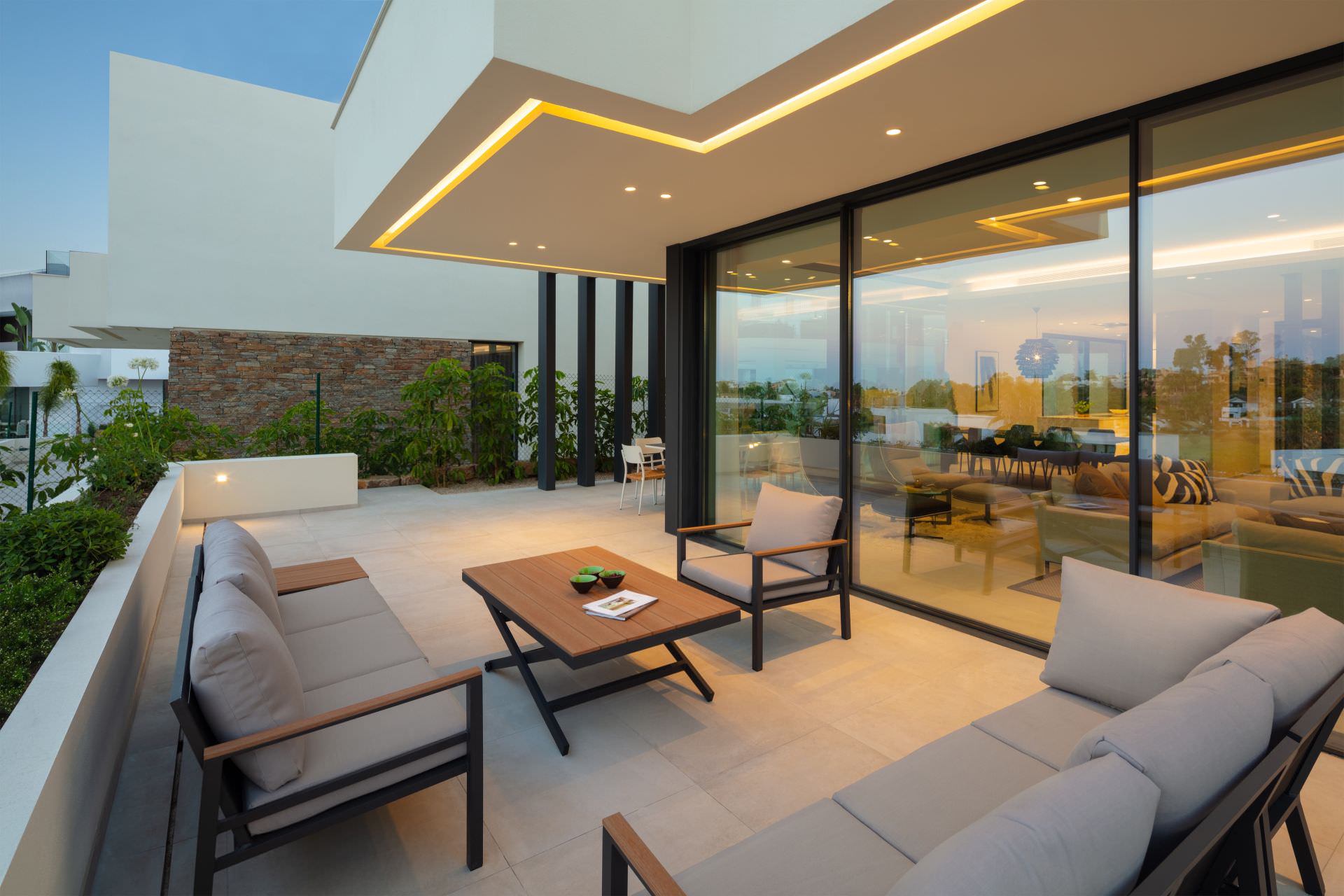 Corner terrace lounge at BELFRY with broad glazing, outdoor seating and refined residential atmosphere