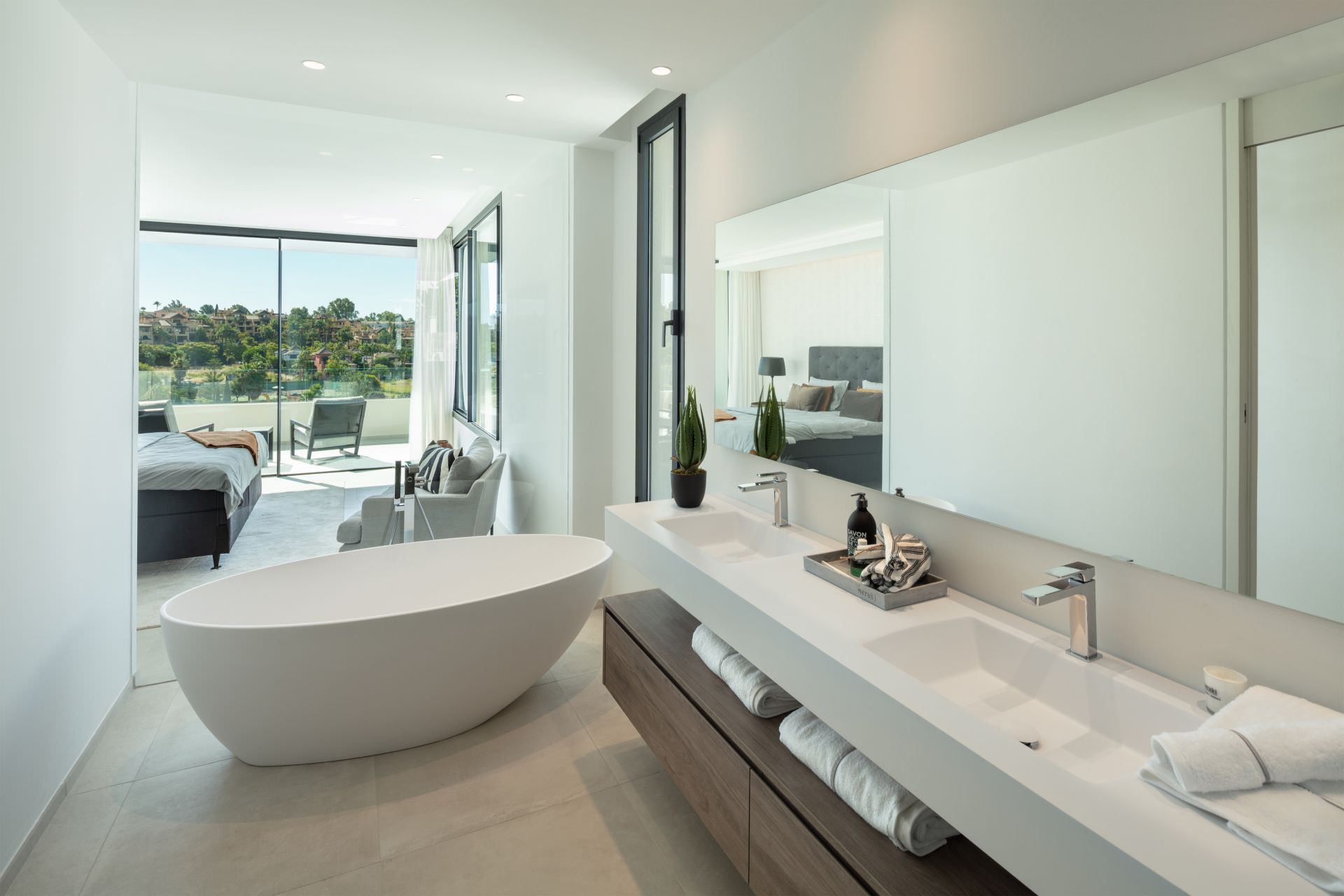 Bathroom at BELFRY with freestanding tub, natural stone surfaces and calm daylight