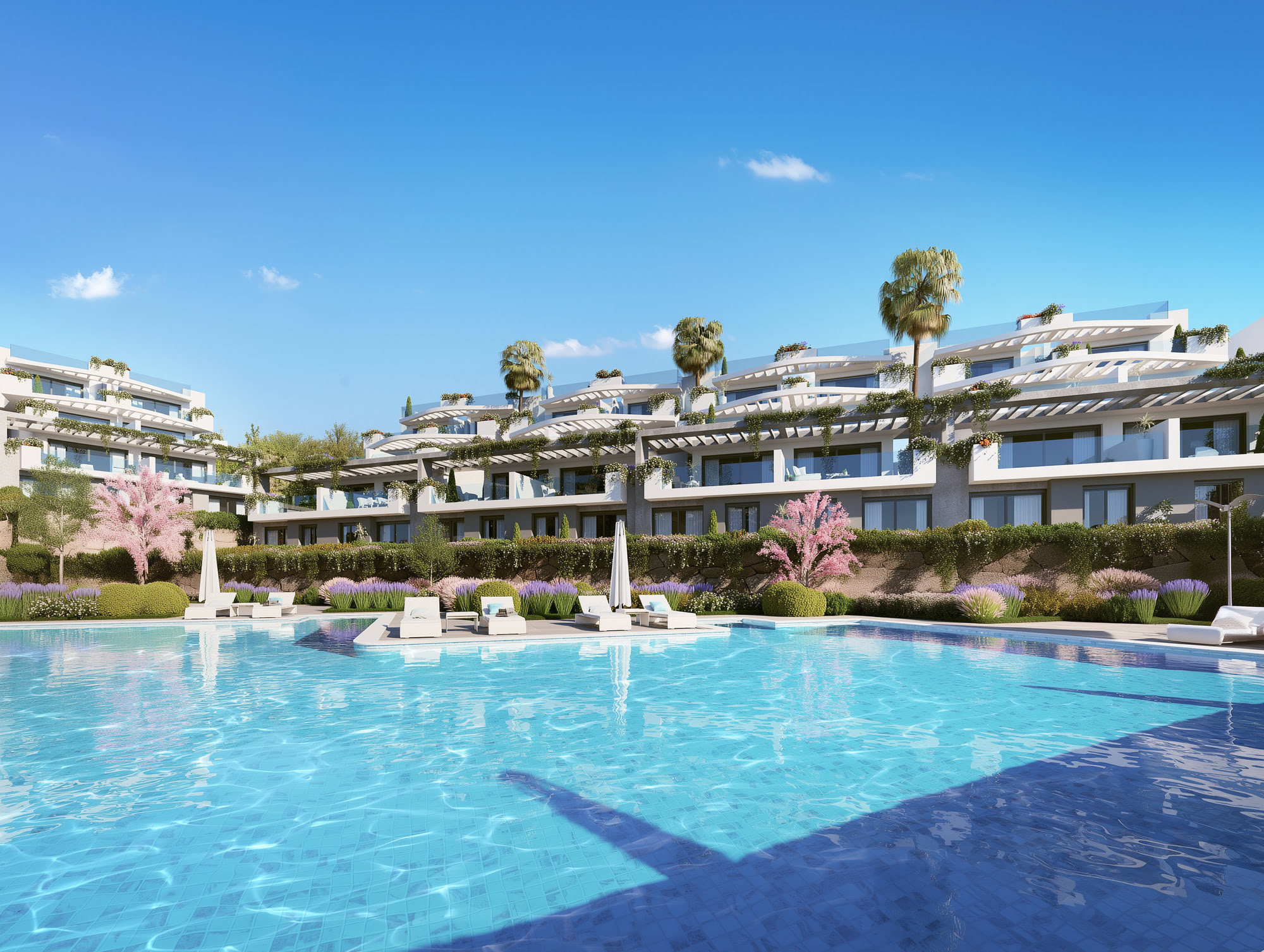 Wide communal pool view at CALASOL with open sky, water reflections and terraced residential blocks