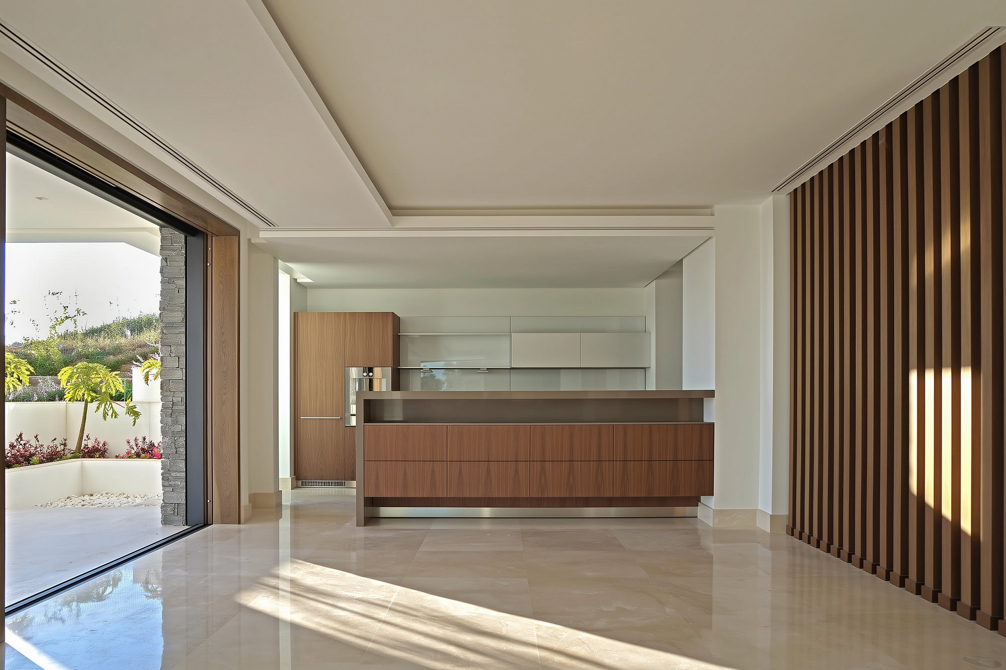 Villa Casalina open plan living room with panoramic glazing, timber finishes and direct terrace connection