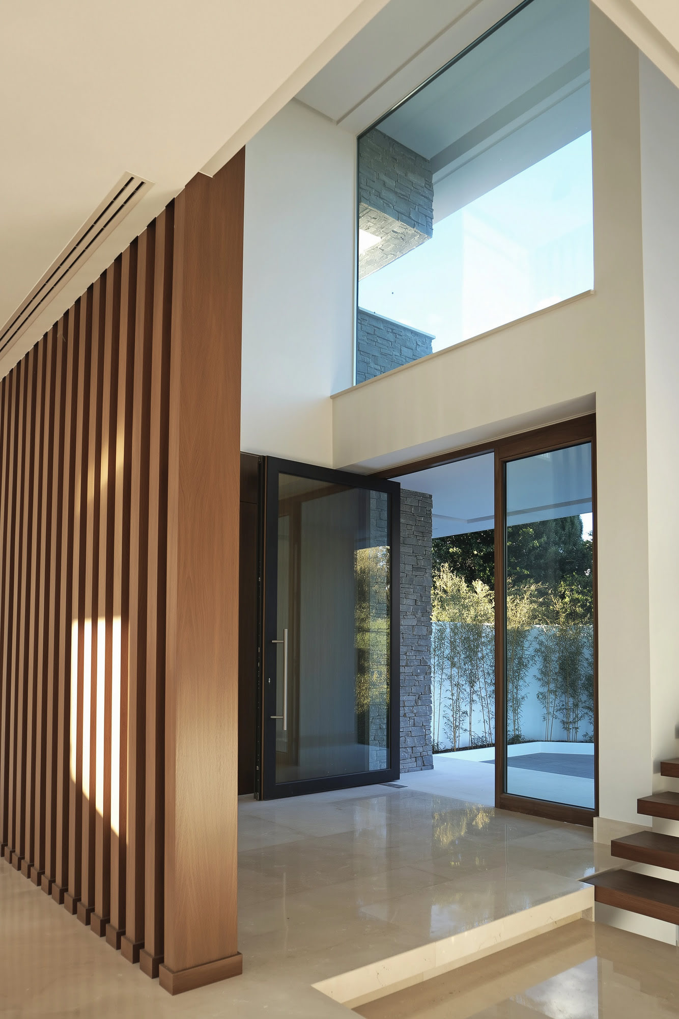 Villa Casalina interior architectural detail with warm timber surfaces, glazing and filtered natural light