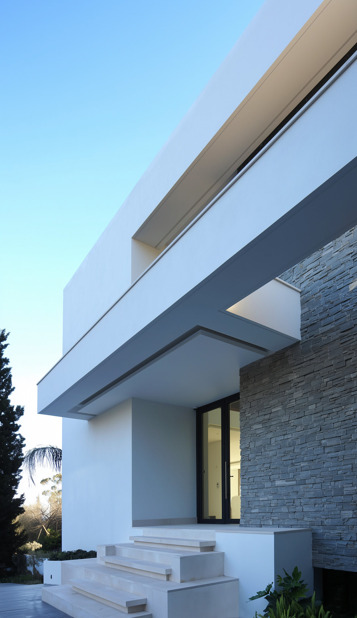 Villa Casalina façade detail with sharp white eaves, stone textures and precise contemporary junctions
