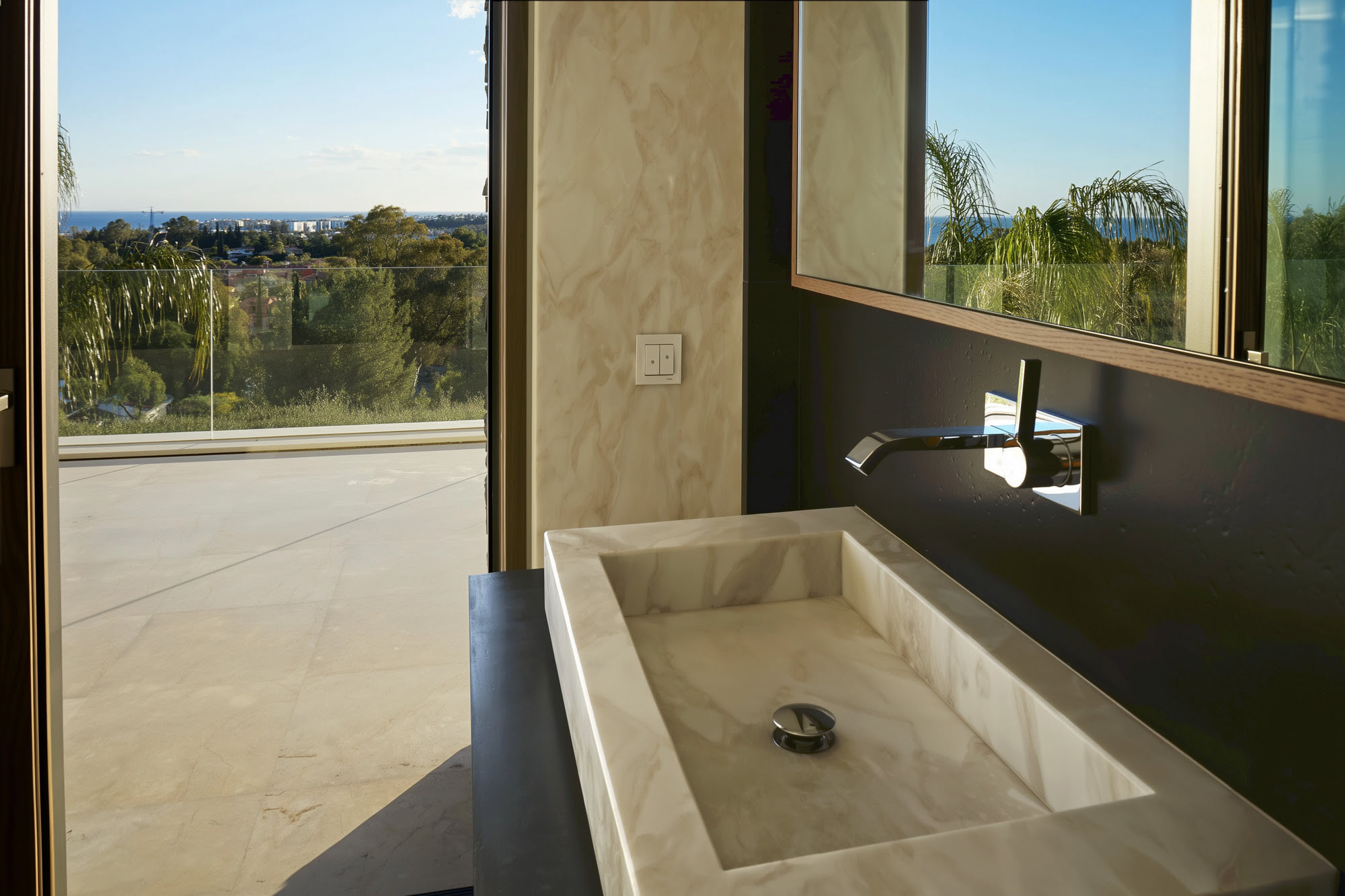 Villa Casalina exterior washbasin detail with stone wall, open air setting and panoramic landscape backdrop