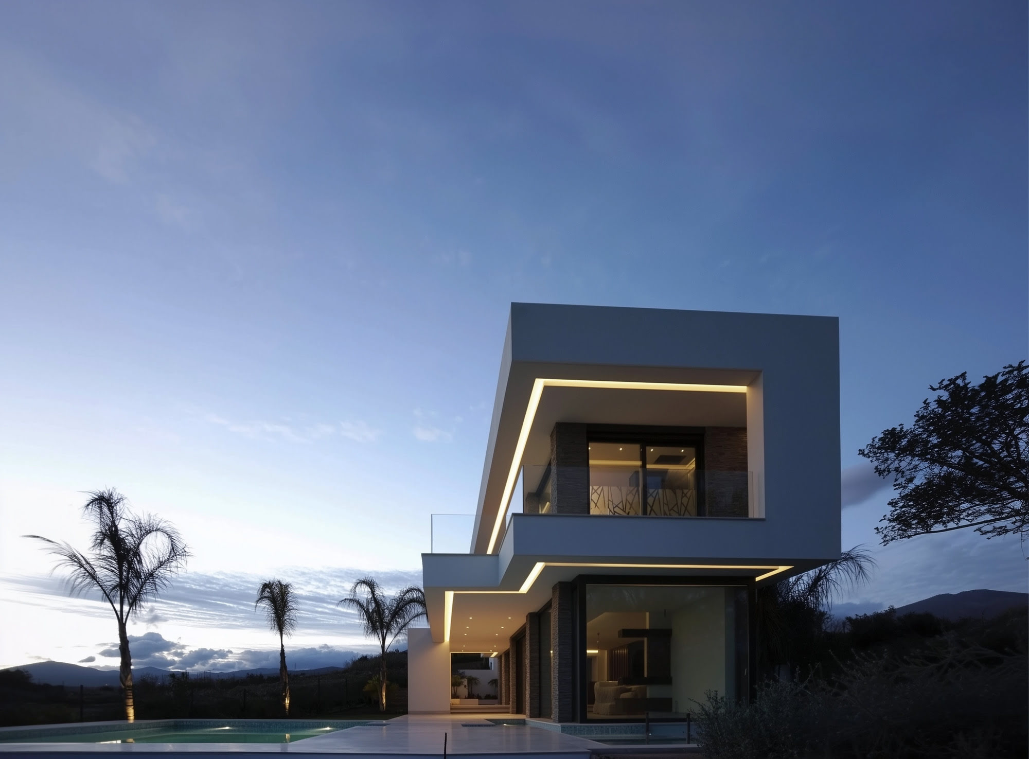 Villa Casalina twilight front elevation with illuminated entrance and sculptural stacked volumes