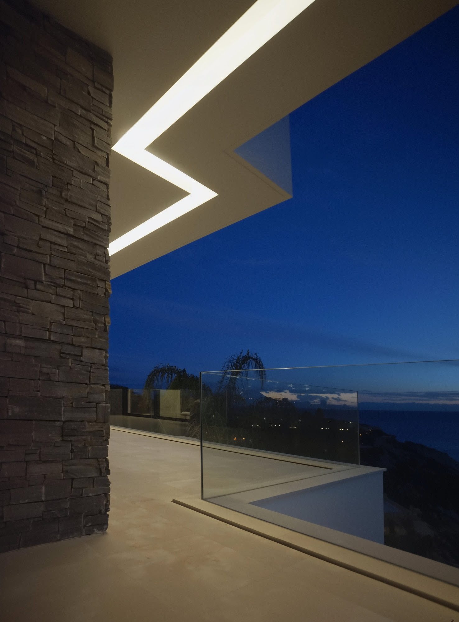 Villa Casalina nighttime terrace detail with linear lighting, deep blue sky and refined geometry