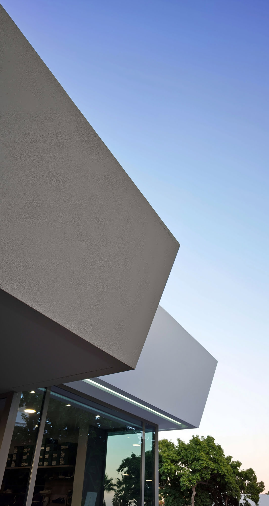 Abstract architectural detail of intersecting white planes and deep cantilever at the Guadalmina clubhouse
