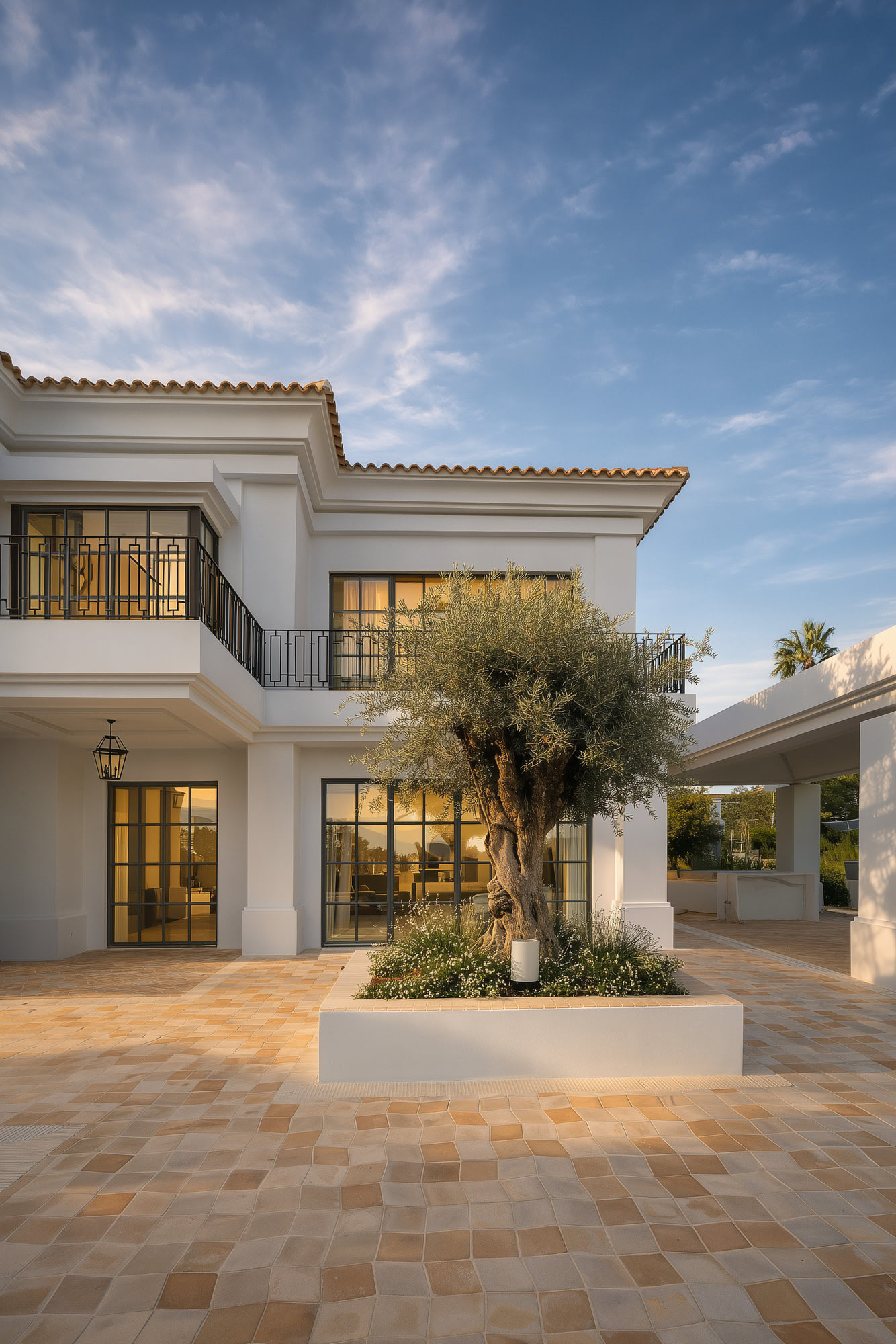 Front entrance courtyard of Villa Diva with stone paving, symmetrical portico and refined classical proportions