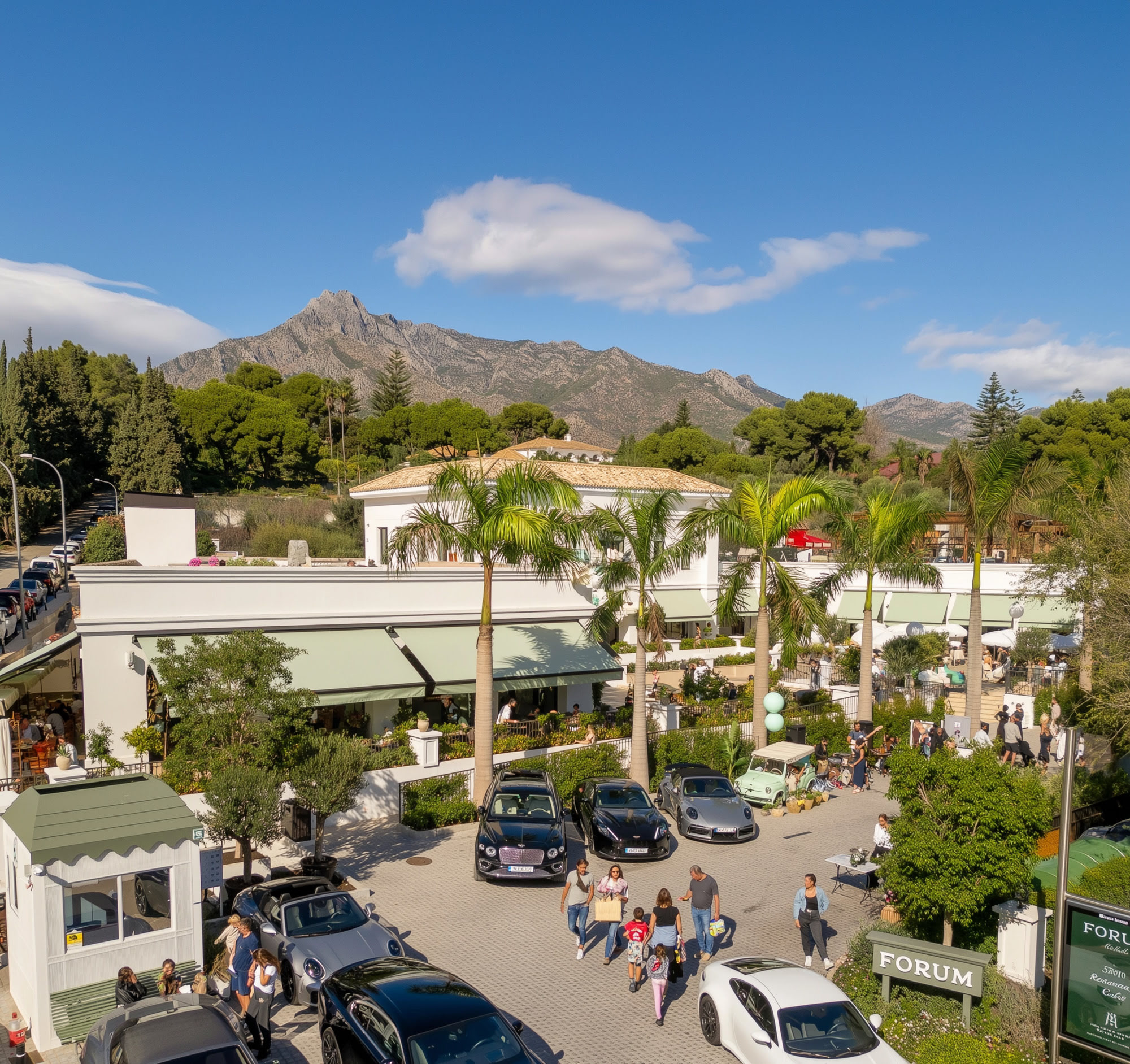 Panoramic view of FORUM on Marbella Golden Mile with La Concha mountain, palm-lined avenues and active urban frontage