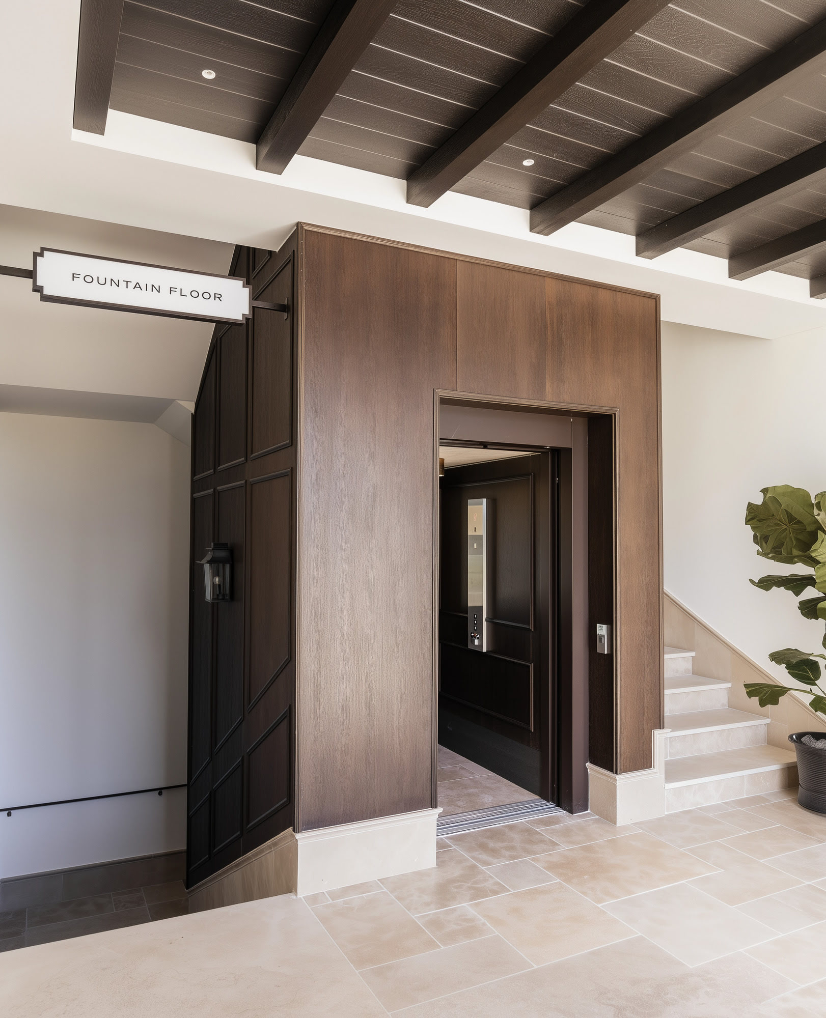 Entrance and signage detail at FORUM highlighting material quality, timber joinery and the refined access sequence