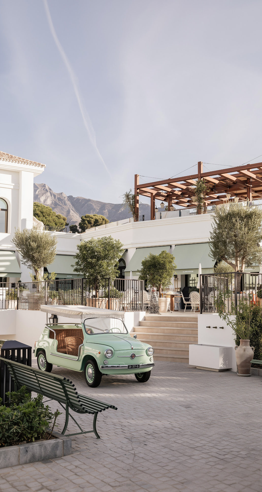 Arrival view into FORUM main plaza with premium parking, landscaped edges and a curated lifestyle atmosphere on Marbella Golden Mile