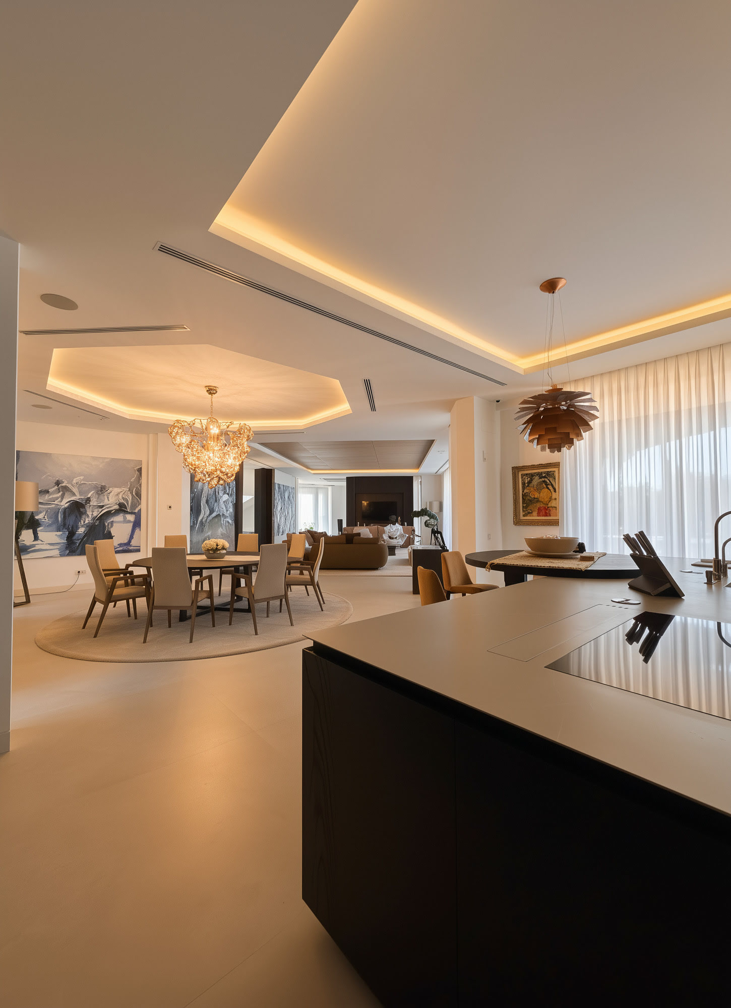 Kitchen and social area at Hillview Estate with sculptural island, warm ceiling lighting and refined contemporary detailing