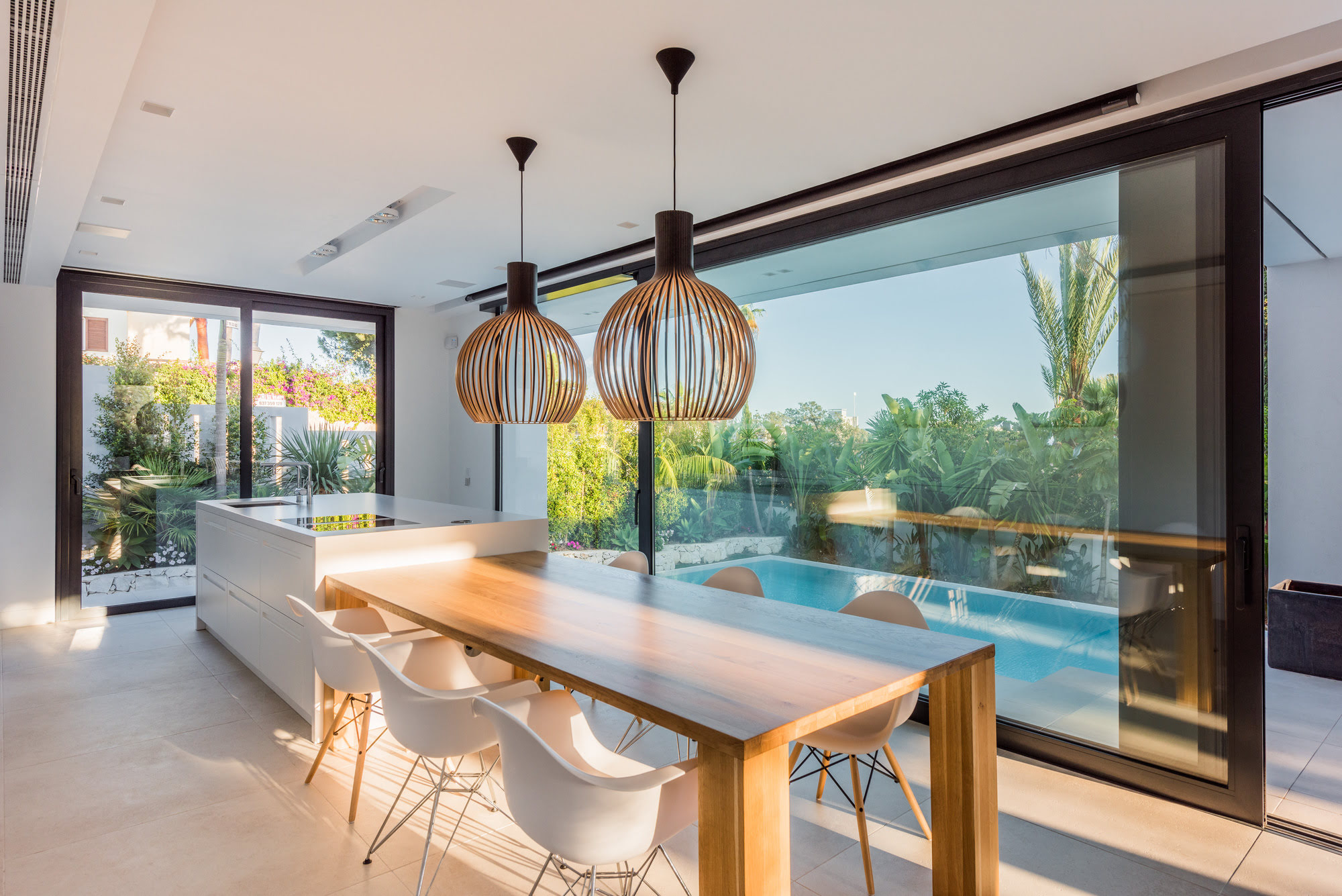 Open plan dining area at M152 connected to the terrace through full height sliding glass doors