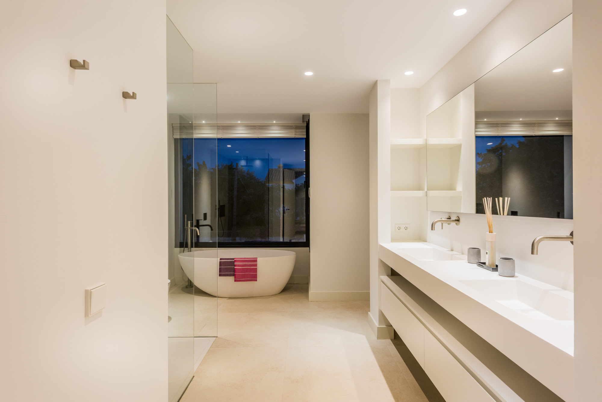 Contemporary bathroom at M152 with freestanding bathtub, dark stone wall and elegant ambient lighting