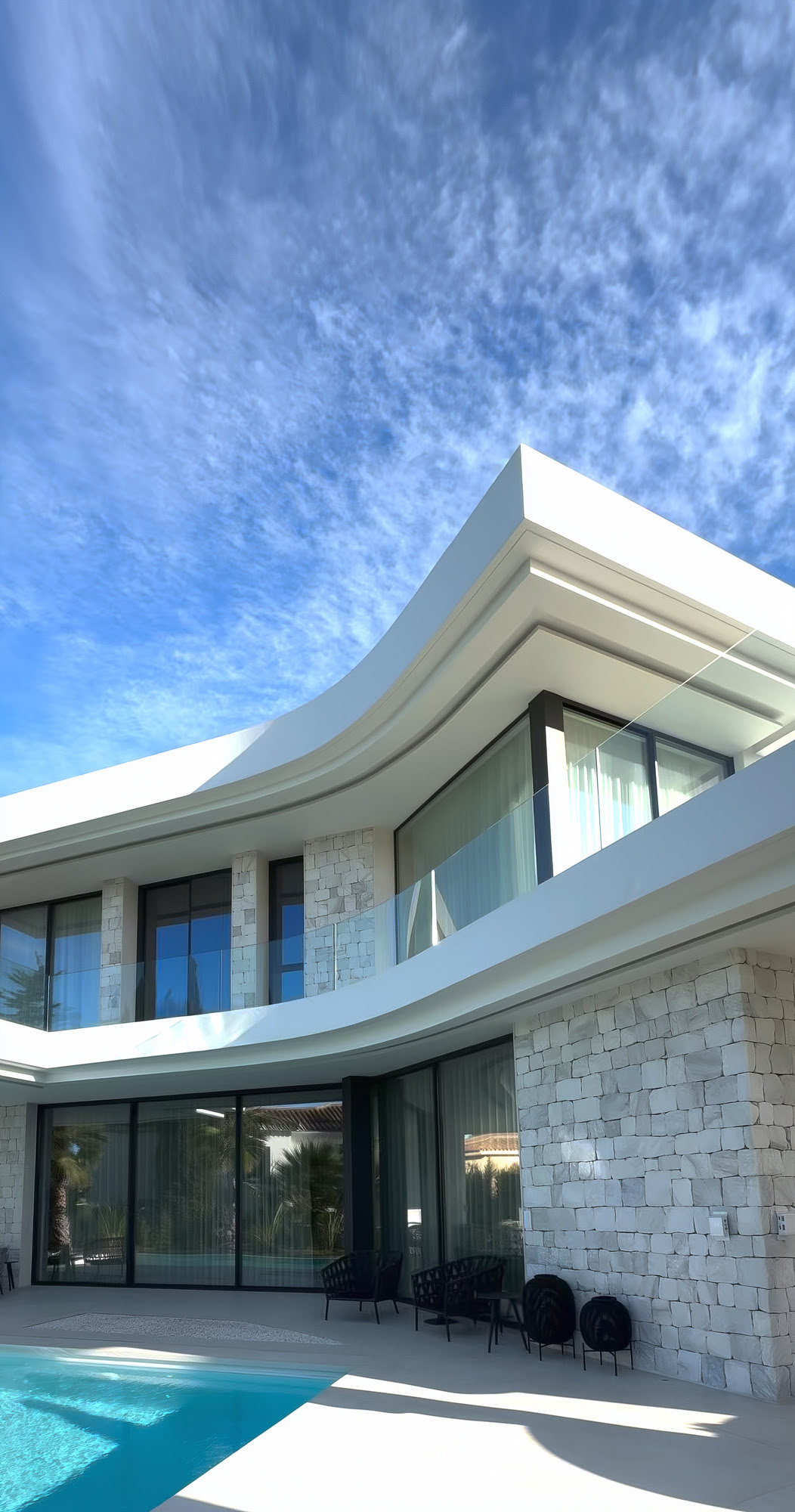 Vertical exterior view of the M94 pool façade highlighting cantilevered terraces and clean contemporary lines