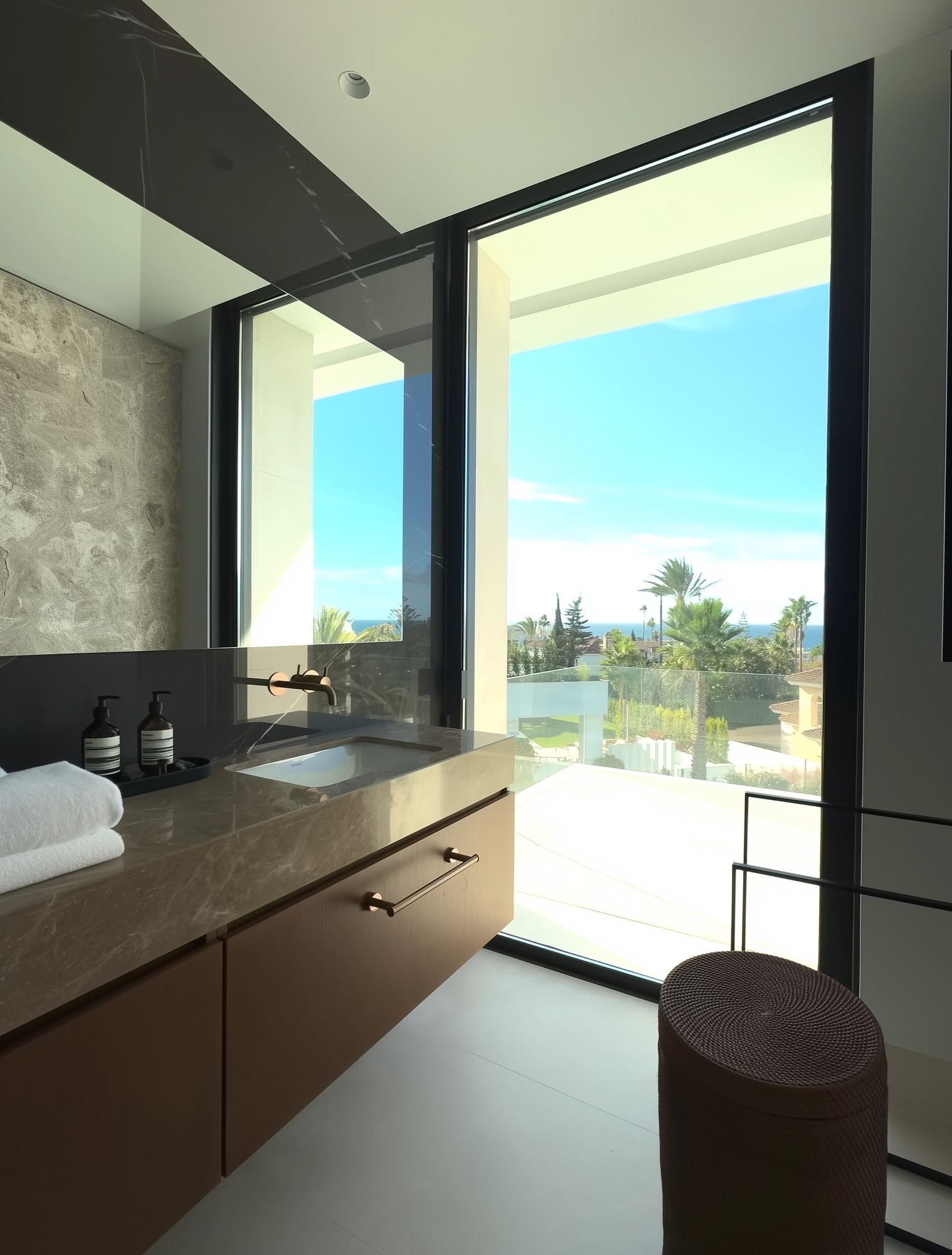 Bathroom vanity at M94 with framed landscape view, timber cabinetry and serene material palette