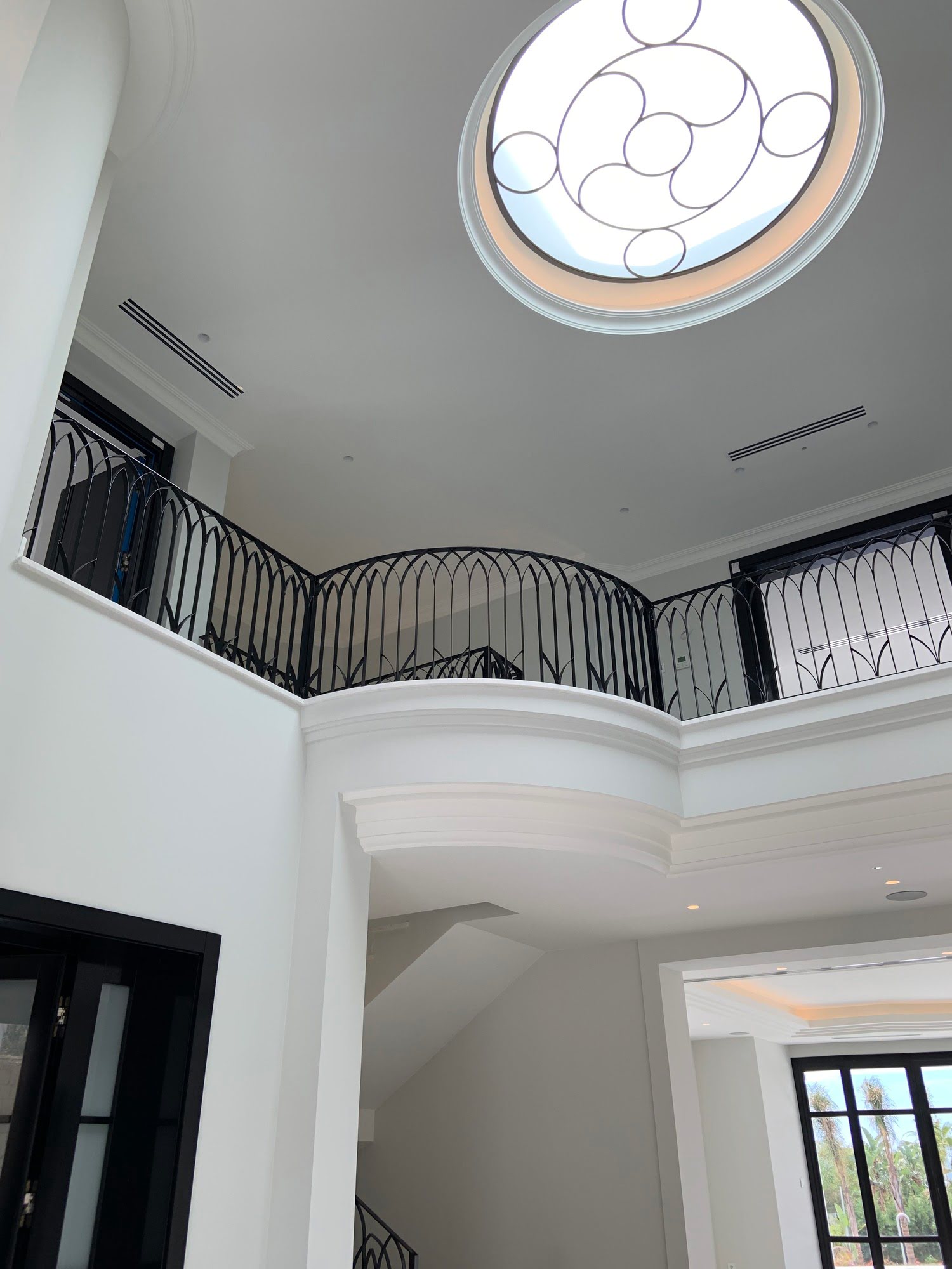 Double-height foyer of Villa Mariselena with curved gallery, circular skylight and formal classical composition