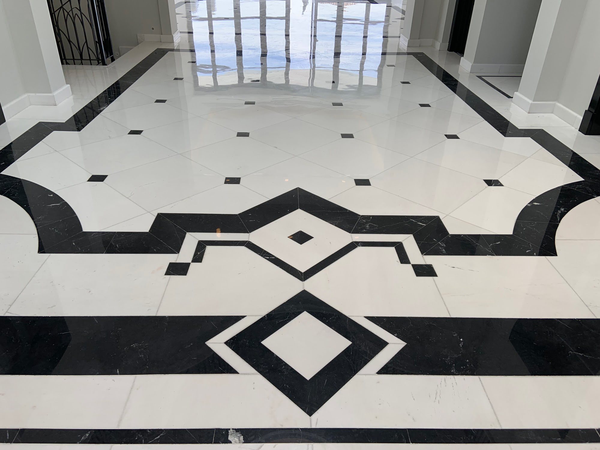 Black and white marble floor pattern detail in the main hall of Villa Mariselena