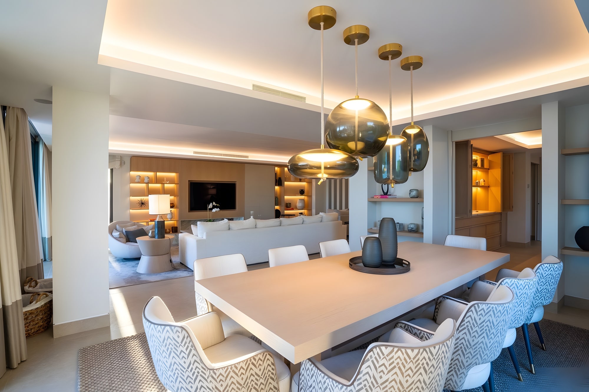 Main kitchen with central island, dining area and soft integrated lighting in this Estepona villa