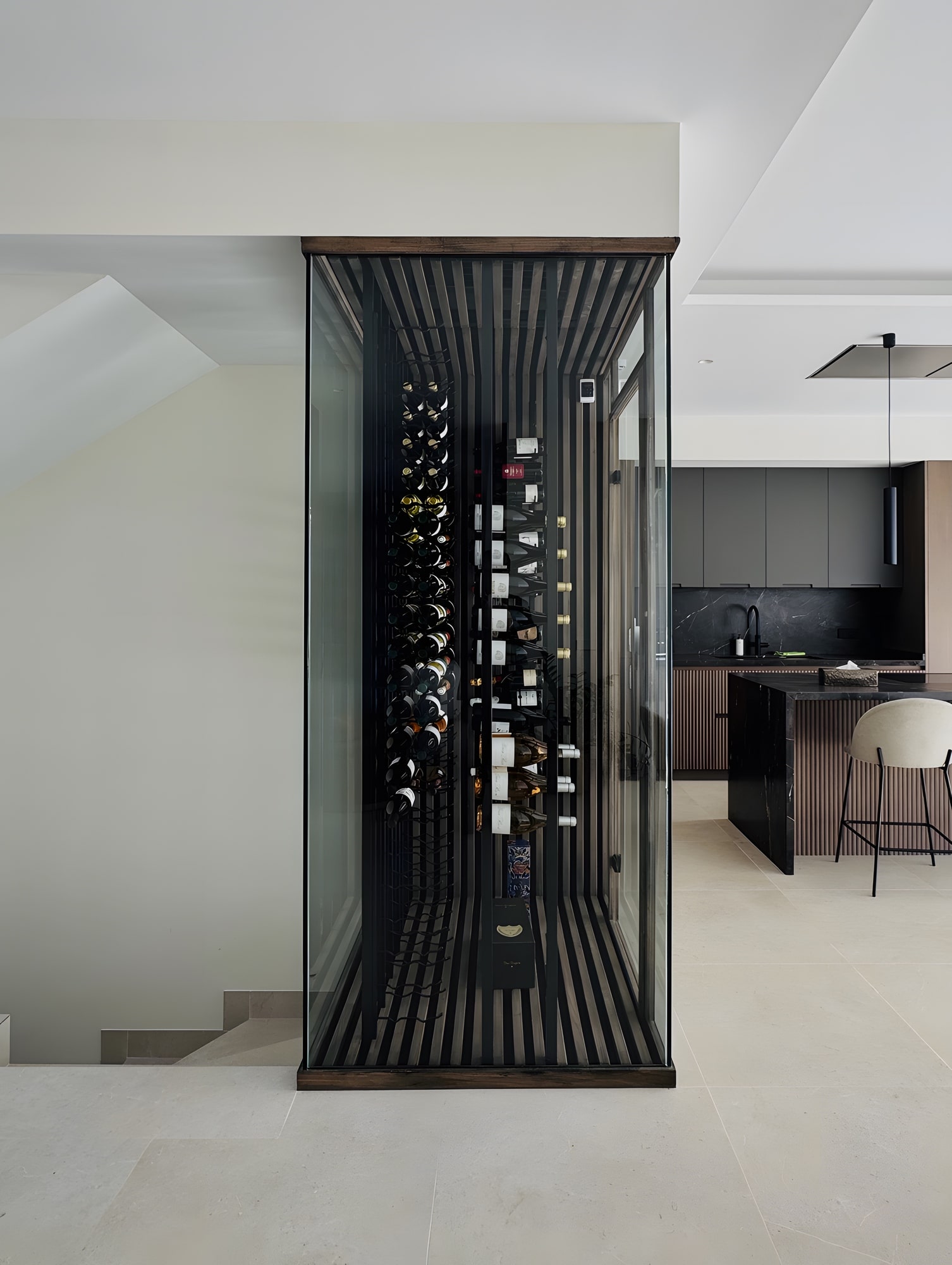 Vertical wine display and circulation core linking kitchen and living spaces