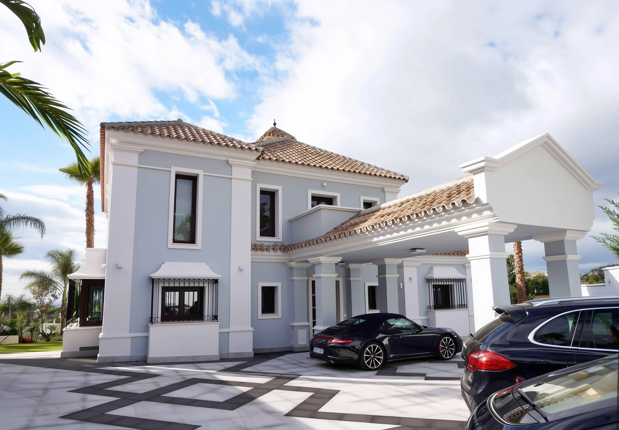 Motor court arrival view of Villa Tanya with driveway, front elevation and Mediterranean composition