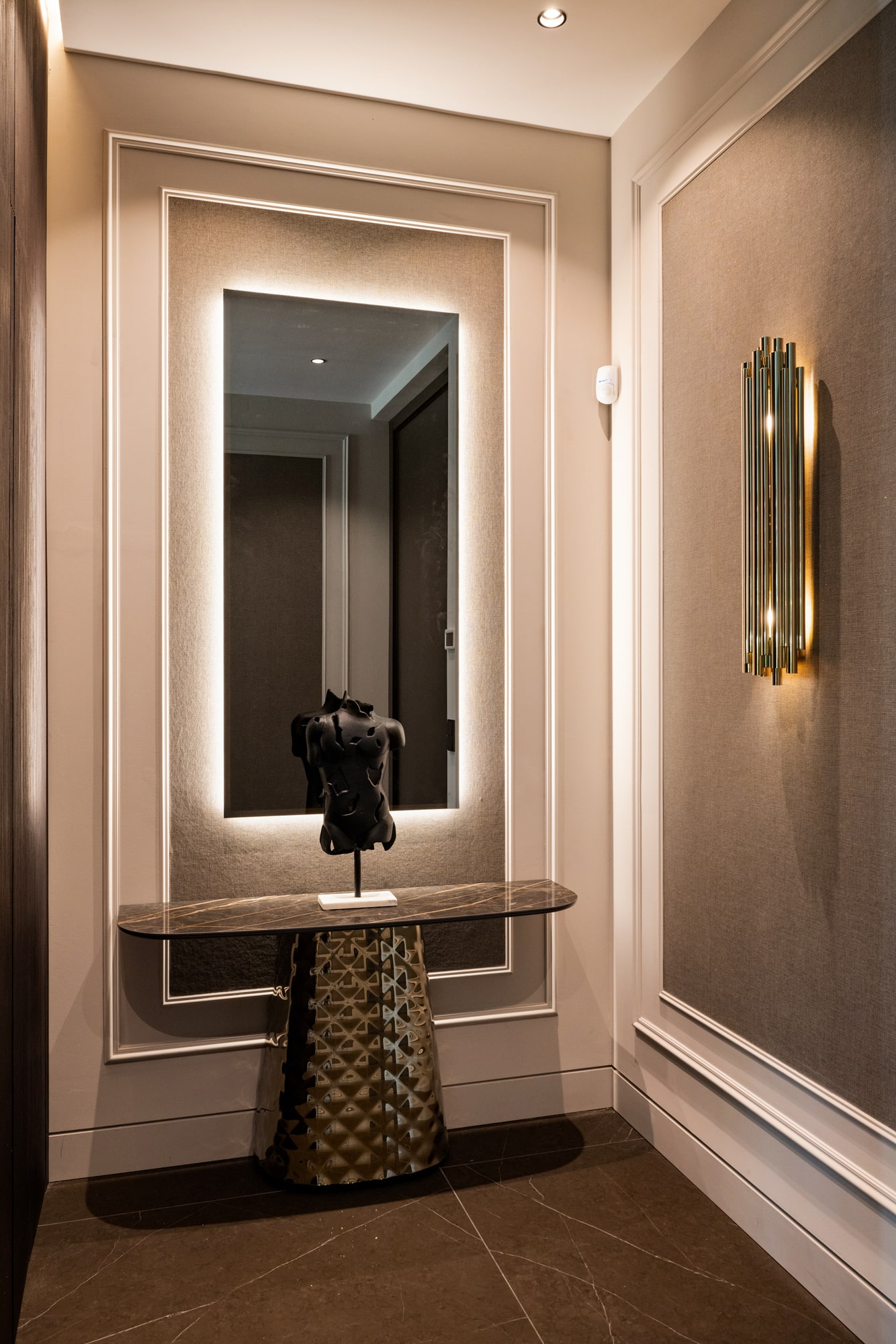 Interior hallway at Casa Velázquez with layered mouldings, warm finishes and intimate architectural lighting