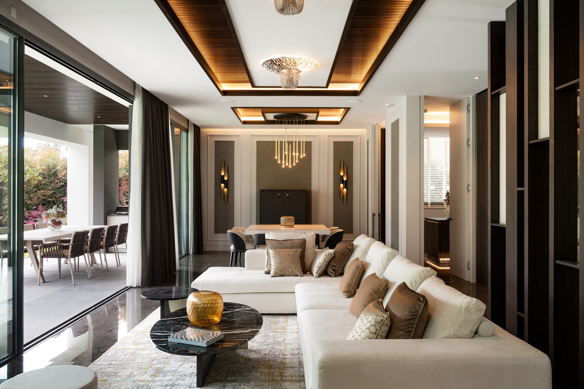 Main living room at Casa Velázquez with full-height glazing, elegant furnishings and a seamless connection to the garden