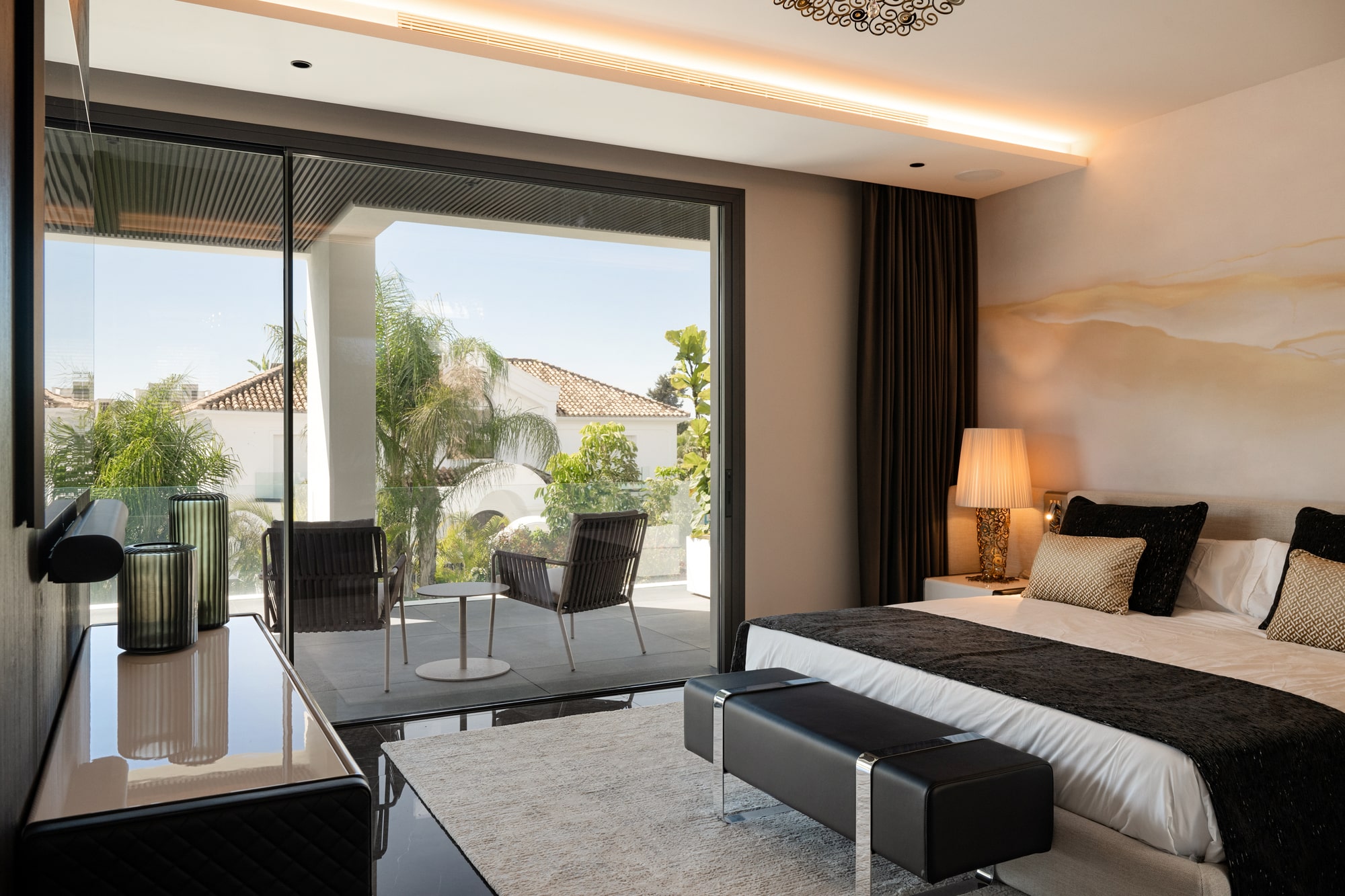 Bedroom lounge at Casa Velázquez with framed views, soft lighting and calm private atmosphere