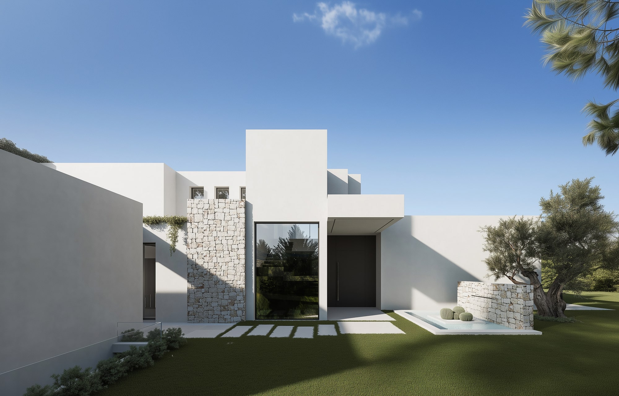 Arrival courtyard of Villa Venezuela in Marbella East with white sculpted volumes, stone walls and a calm sequence of entry spaces