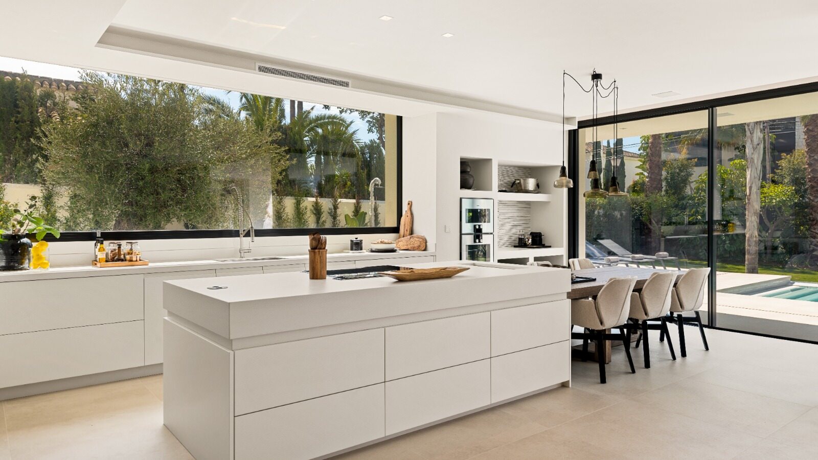 Contemporary kitchen at VIDA DEL MAR with central island, natural light and garden-facing openness