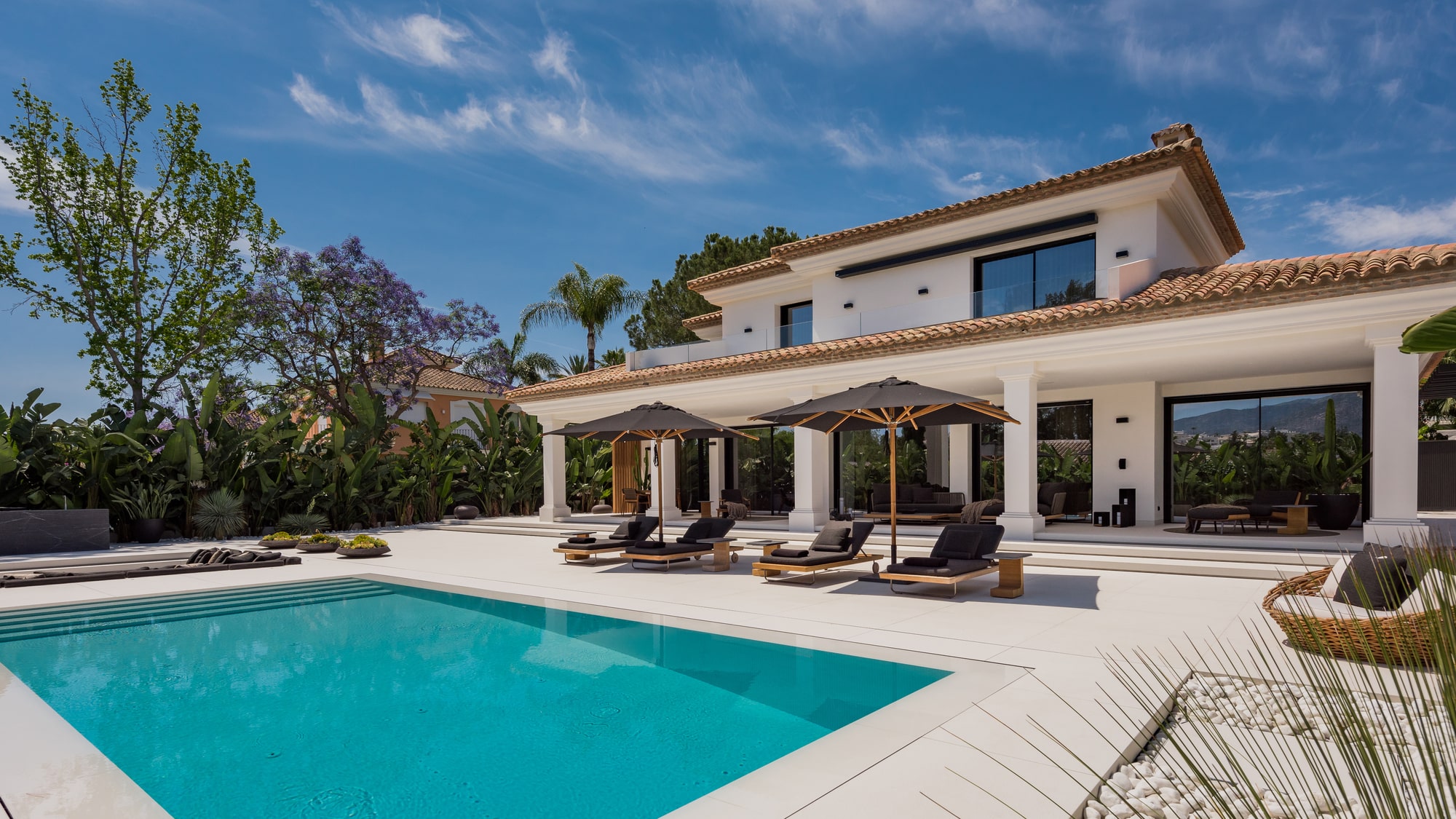 Daylight pool façade of Villa Zarina showing covered terraces, elegant proportions and seamless indoor-outdoor living in La Cerquilla