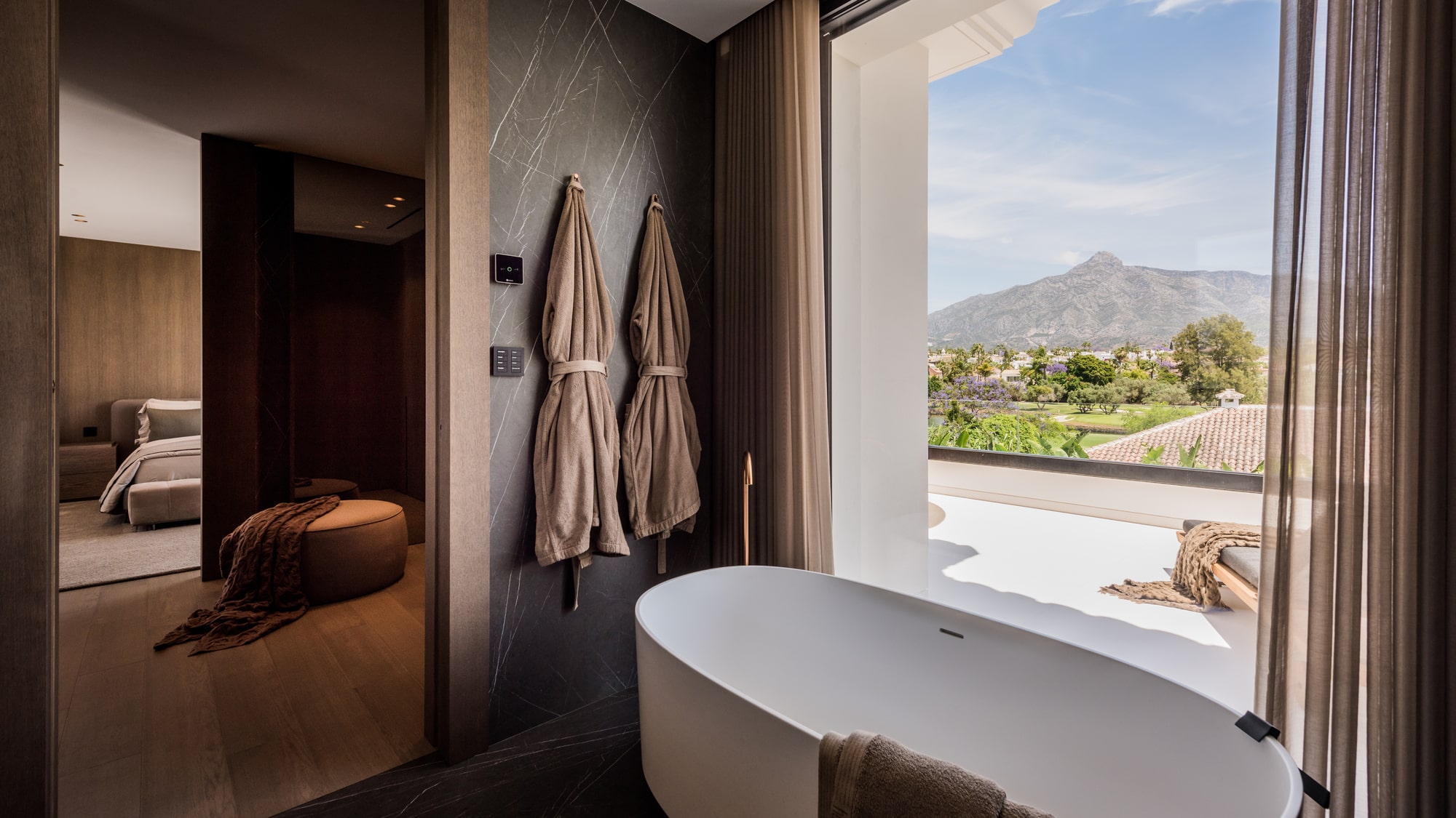 Bedroom and dressing sequence at Villa Zarina with warm wood detailing, curated lighting and terrace outlook