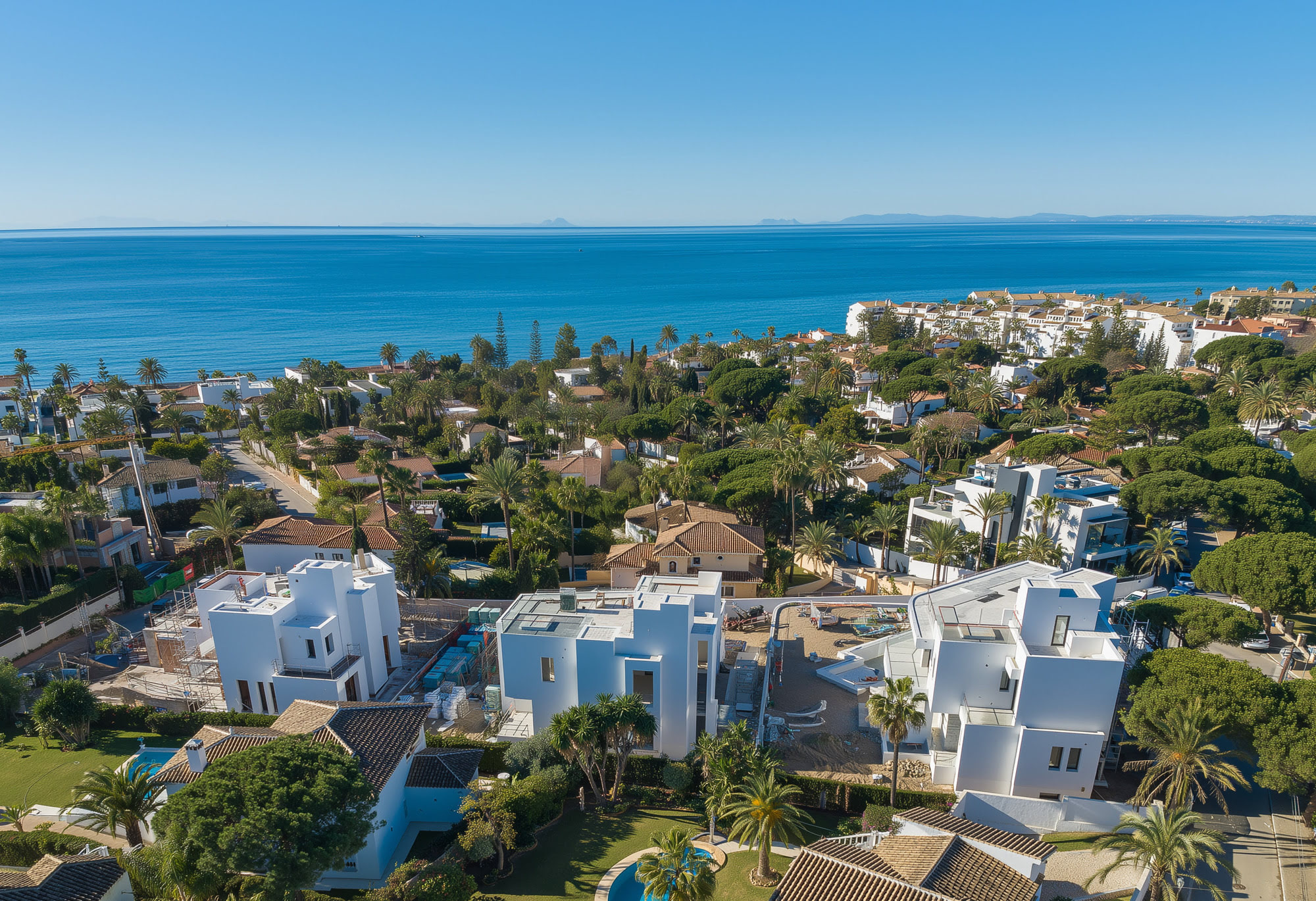 M94 – aerial view of three contemporary villas near the sea in Marbella